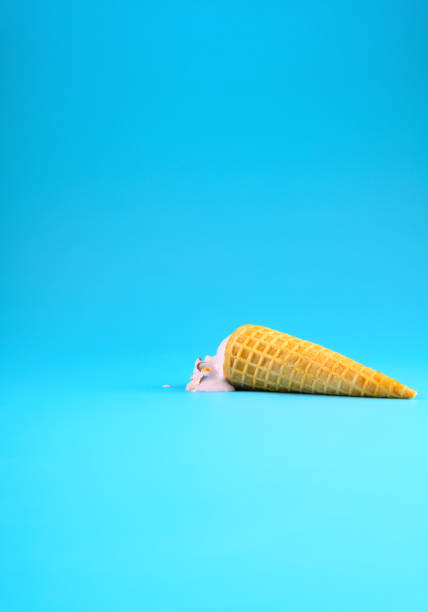 istock sweet potato flavor ice cream cone in a melting process on blue background vertical composition 1252537914