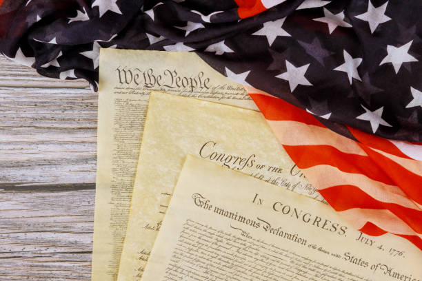 istock Aged historical documents Washington DC on American Declaration of independence 4th july 1776 on USA flag 1252559381