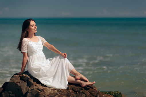 Relaxed girl enjoying ocean waves all alone in summer