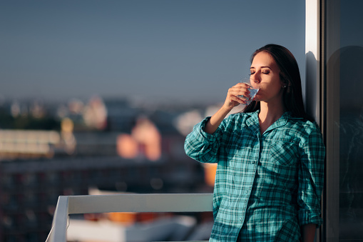 Thirsty girl hydrating first thing after waking up