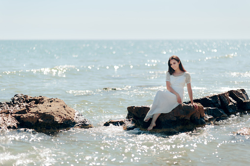 Relaxed girl enjoying ocean waves all alone in summer