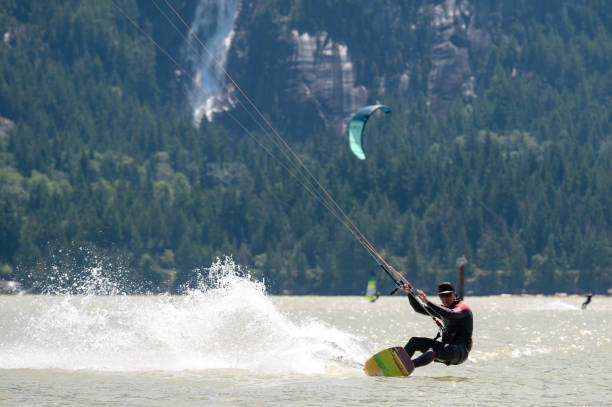 istock Man kiteboarding along the coast 1252563577