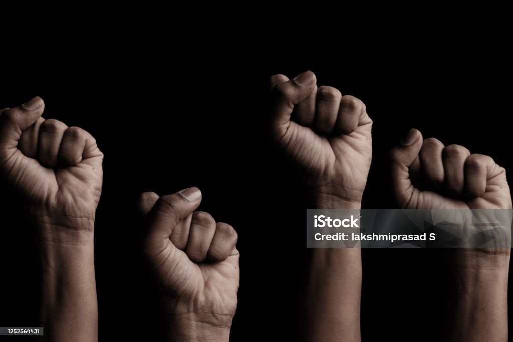 Concept against racism or racial discrimination by showing with hand gestures fist or solidarity Concept against racism or racial discrimination by showing with hand gestures fist or solidarity. Black Color Stock Photo