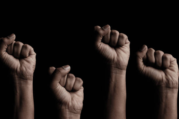 Concept against racism or racial discrimination by showing with hand gestures fist or solidarity Concept against racism or racial discrimination by showing with hand gestures fist or solidarity. peace demonstration photos stock pictures, royalty-free photos & images
