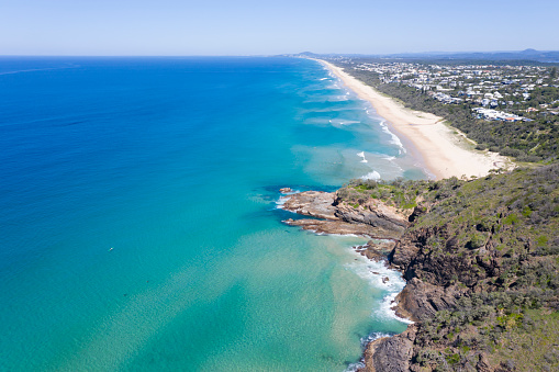 Looking down the coast from the Noosa National Park at Sunshine Beach towards Coolum Beach on a sunny day