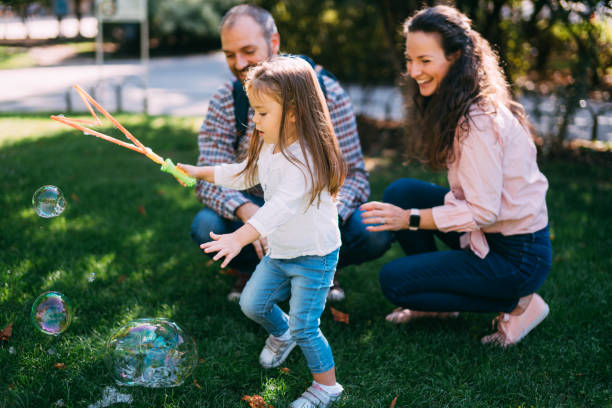istock Family having fun in park with soap bubbles. 1252568134