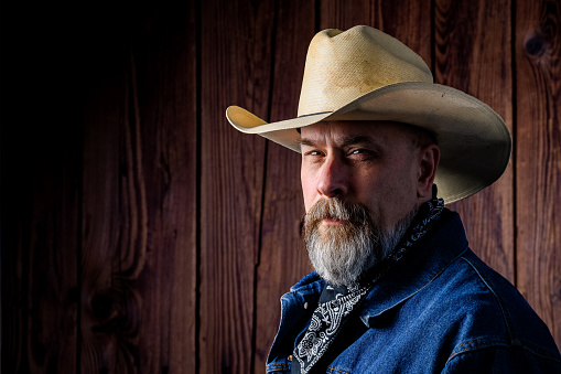 man with gray beard wearing a cowboy hat