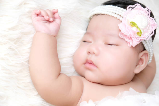istock Cute newborn baby sleep on white fabric background. 1252580538