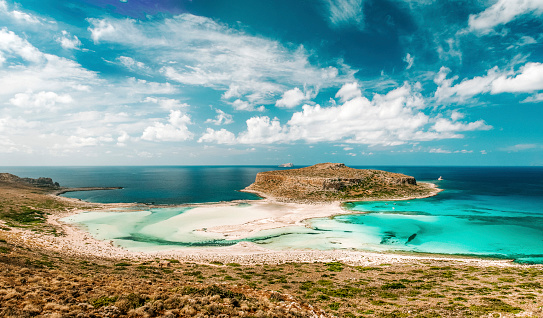 The tropical island of Balos surrounded by transparent turquoise ocean. Located at the Crete island in Greece, seen a hot day in the summer.