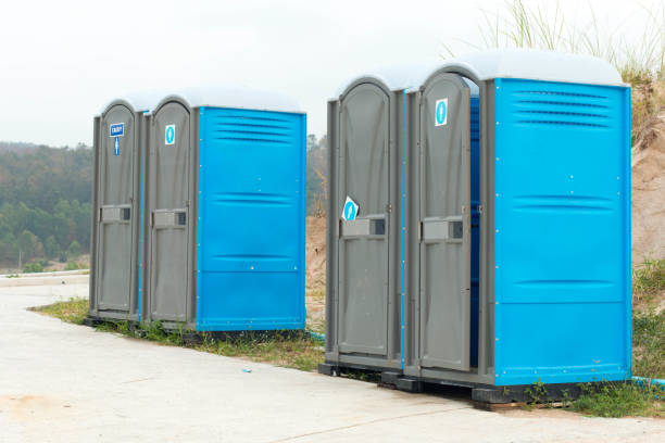 istock Two blue portable toilet cabins at construction site 1252583600