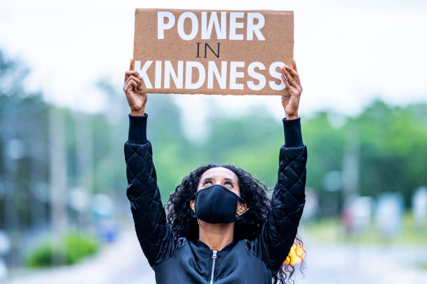 istock Young African American woman holding protest sign 1252583708