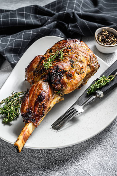 istock BBQ lamb leg with herbs. Gray background. Top view 1252584743