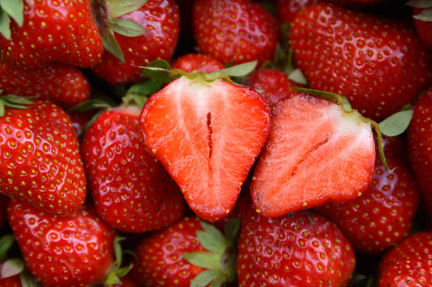 istock ripe strawberry cut in half close up 1252585798