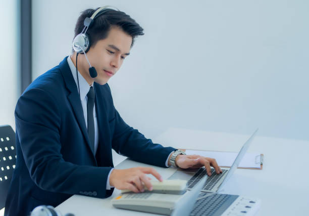 istock Portrait of happy smiling male customer support phone operator at workplace. 1252586084