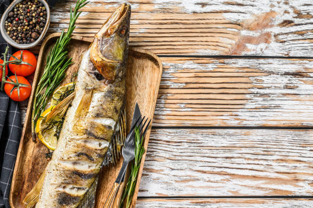 istock Grilled pike perch, pikeperch fish. White wooden background. Top view. Copy space 1252588040