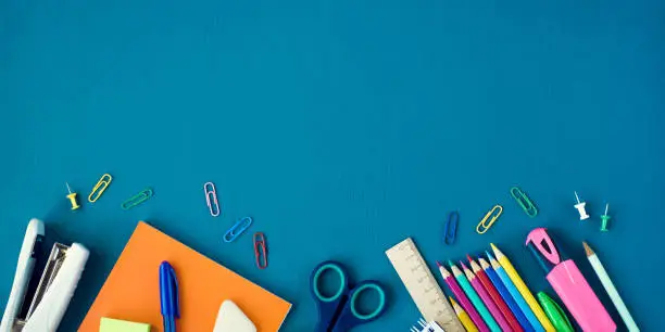 Photo of School supplies on blue background