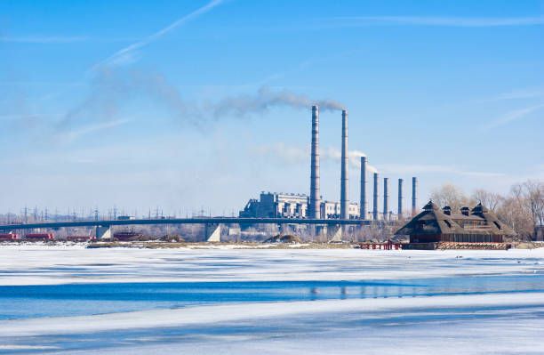 Electric power station beside a river - winter industrial landscape in Ukraine.