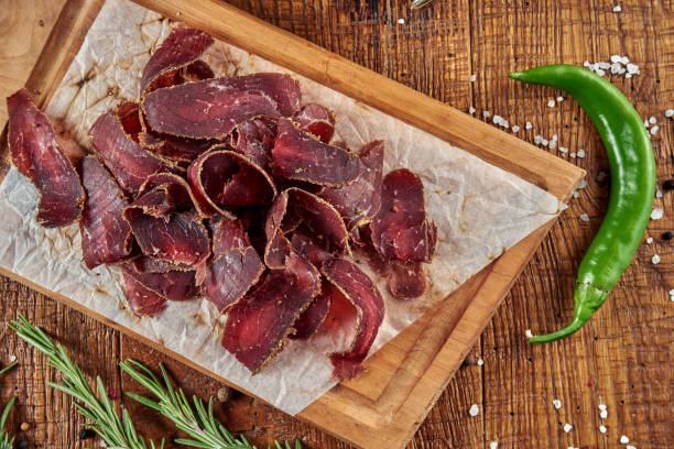 an appetizing beer snack is basturma, a traditional armenian dried meat (pork or beef). close up on tasty jerky snack - beef jerky meat smoked imagens e fotografias de stock