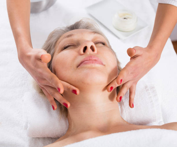 istock Mature woman having face massage 1252602681