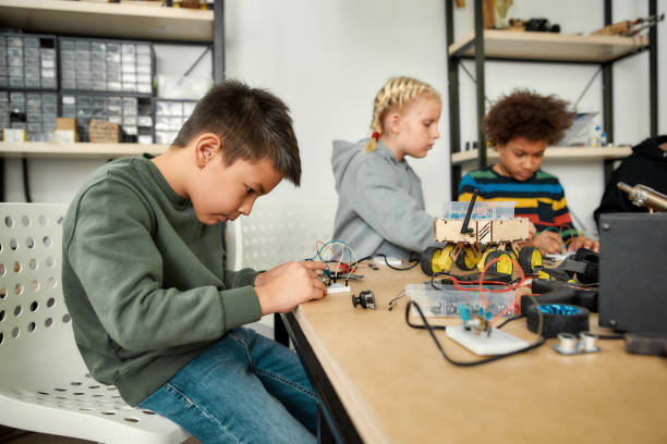 istock Excellence in every experience. Young technicians making toys at a technology class. Smart kids and STEM education. 1252604000