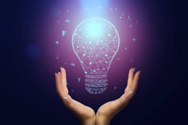 istock Birth of creative idea. Female hands holding digital hologram glowing light bulb 1252605580