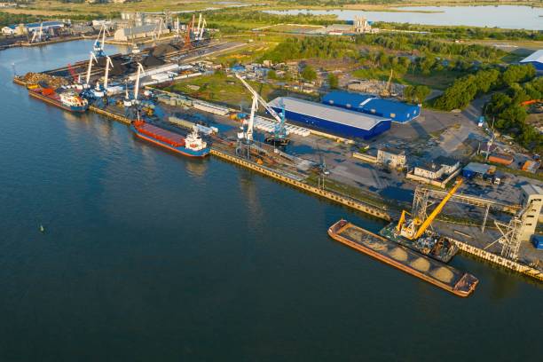istock Marine cranes at the pier ready for loading bulk cargo onto a barge. 1252605753
