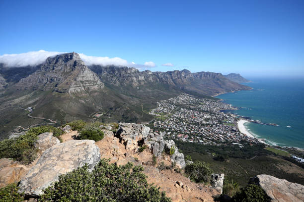 A view of Table Mountain, Twelve Apostles and Camps Bay in Cape Town, South Africa. A general view of Table Mountain, the Twelve Apostles and Camps Bay from the top of Lions Head in Cape Town, South Africa table mountain and the tablecloth stock pictures, royalty-free photos & images