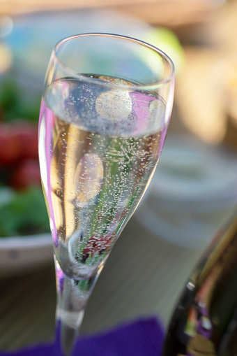 Single champagne flute at an English garden party in Summer.