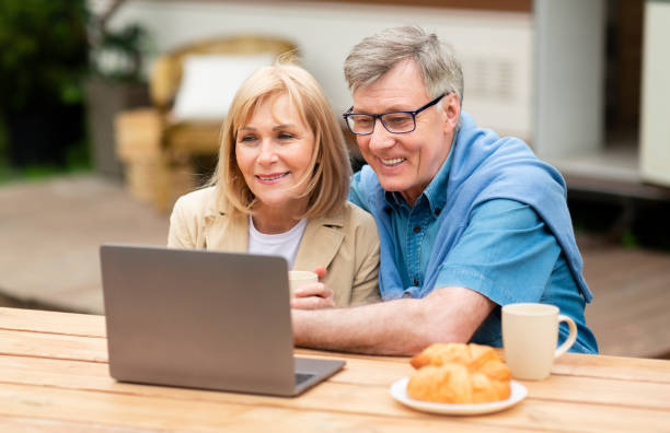 istock Mature woman with her husband browsing internet on laptop at campground 1252607320