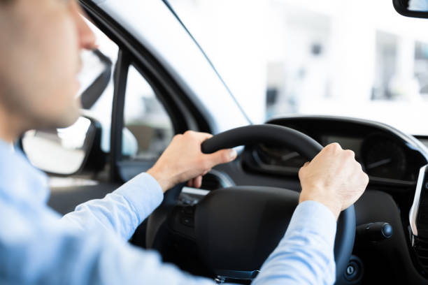 istock Young caucasian man driving his new car 1252607437