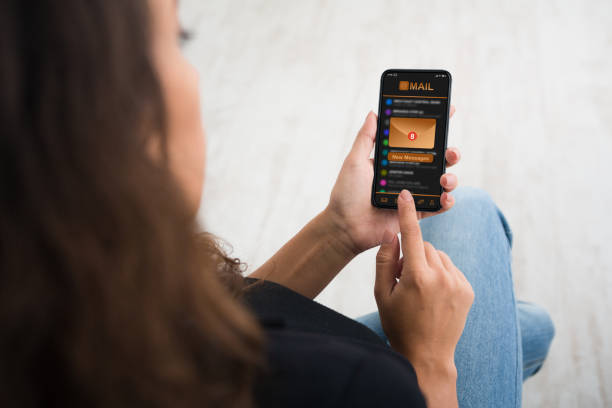 istock New Email. Woman Holding Smartphone With Inbox Mail Messages Notification On Screen 1252607566