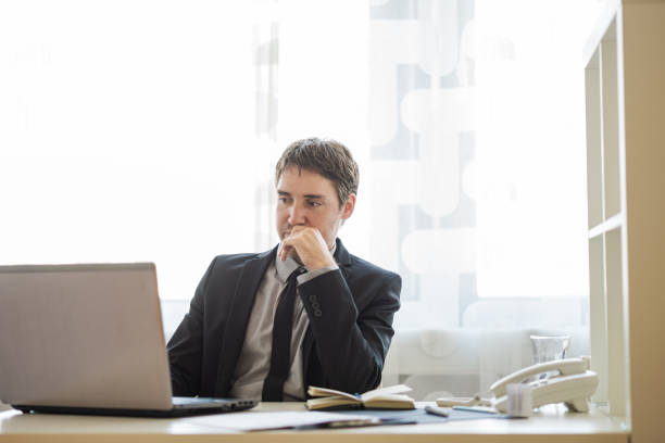 istock Young businessman working on laptop computer in his office 1252609798