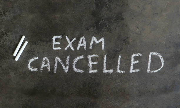 istock Exam Cancelled Written with White Chalk on Blackboard 1252610879
