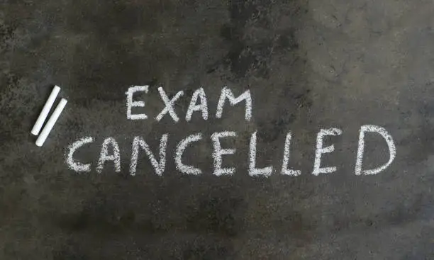 Photo of Exam Cancelled Written with White Chalk on Blackboard