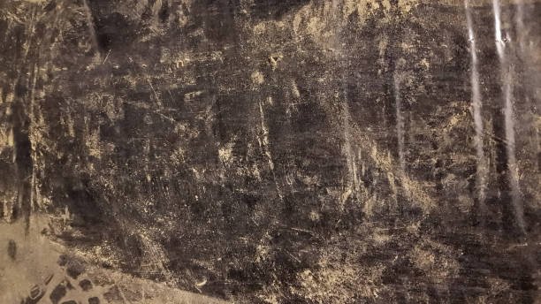 istock Abstract background of dirty black polyethylene in the dust. Copy space 1252613416