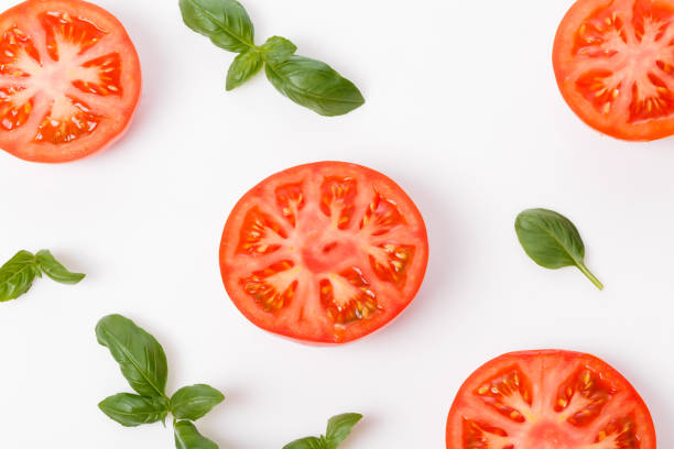 istock Slice of fresh tomato closeup, isolated on white, 1252613509