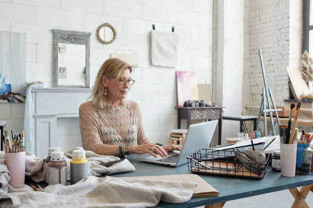 istock Artist typing on laptop in own studio 1252614453