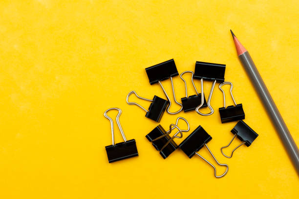istock bulldog paperclips isolated on yellow background 1252615890