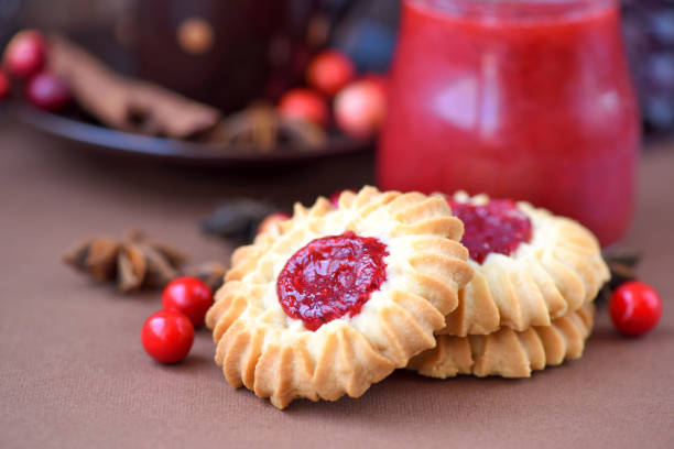 istock Shortbread cookies with jam in the middle on plate against brown background 1252617231