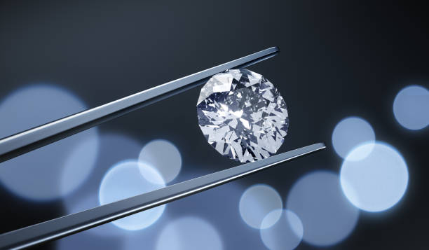 Large Diamond with Tweezers Large Diamond with Tweezers on bokeh lights background diamond shaped photos stock pictures, royalty-free photos & images