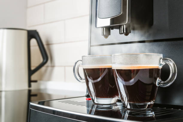 istock cups with hot coffee poured from the coffee machine 1252617785