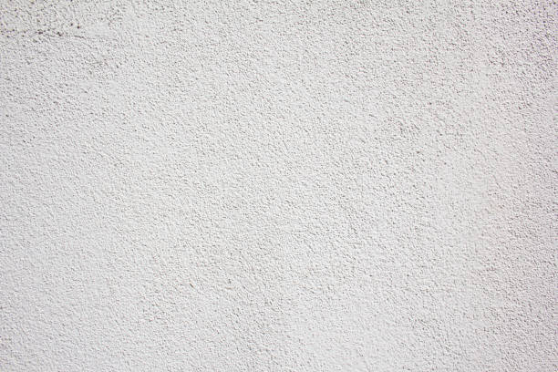 istock White painted grungy wall with rough surface texture background. 1252619571