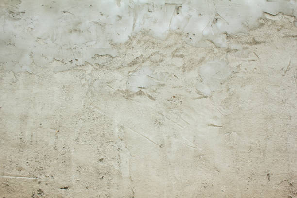 istock Grey concrete wall with cement and plaster on rough surface texture background. 1252619591