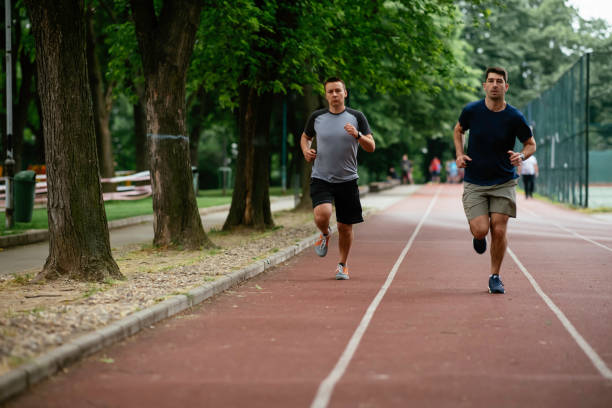 istock Two young friends running on athletics track 1252621353