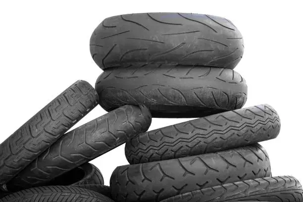 Photo of Pile of old motorcycle tires on white background