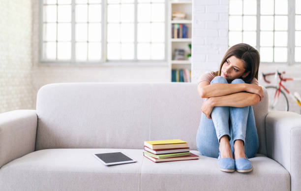 istock Tired woman sitting on a sofa at home 1252622189