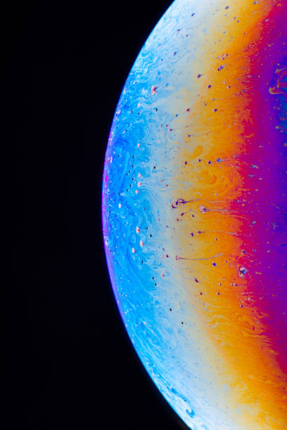 istock Macro shot of a soap bubble hemisphere. Abstract colorful liquid background. 1252625549