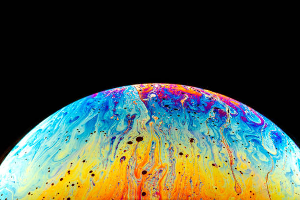 istock Macro shot of a soap bubble hemisphere. Abstract colorful liquid background. 1252625552