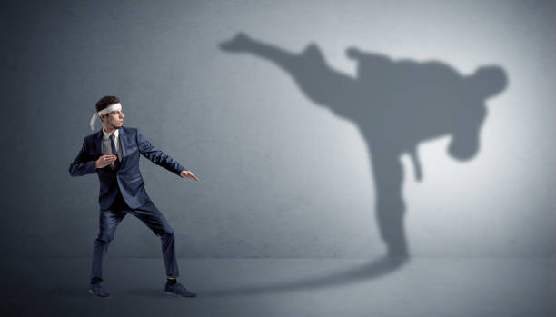 istock Karate man confronting with his own shadow 1252627387