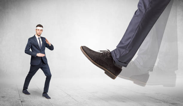 istock Big foot trample suited karate man 1252627413